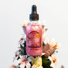Circe Boutique Self Love Ritual Body Oil featuring a glass bottle with a dropper and golden oil, designed for confidence and heart healing.