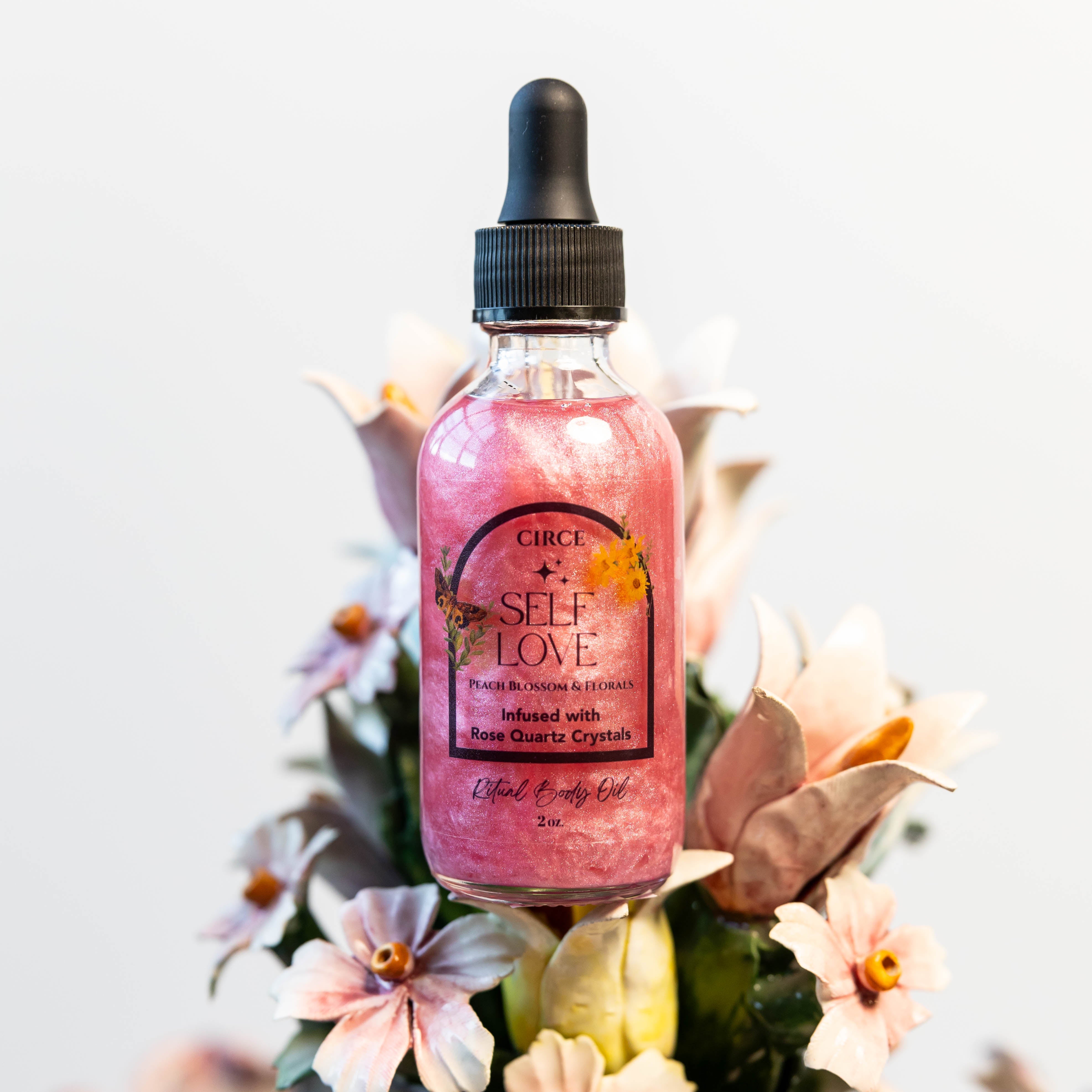 Circe Boutique Self Love Ritual Body Oil featuring a glass bottle with a dropper and golden oil, designed for confidence and heart healing.
