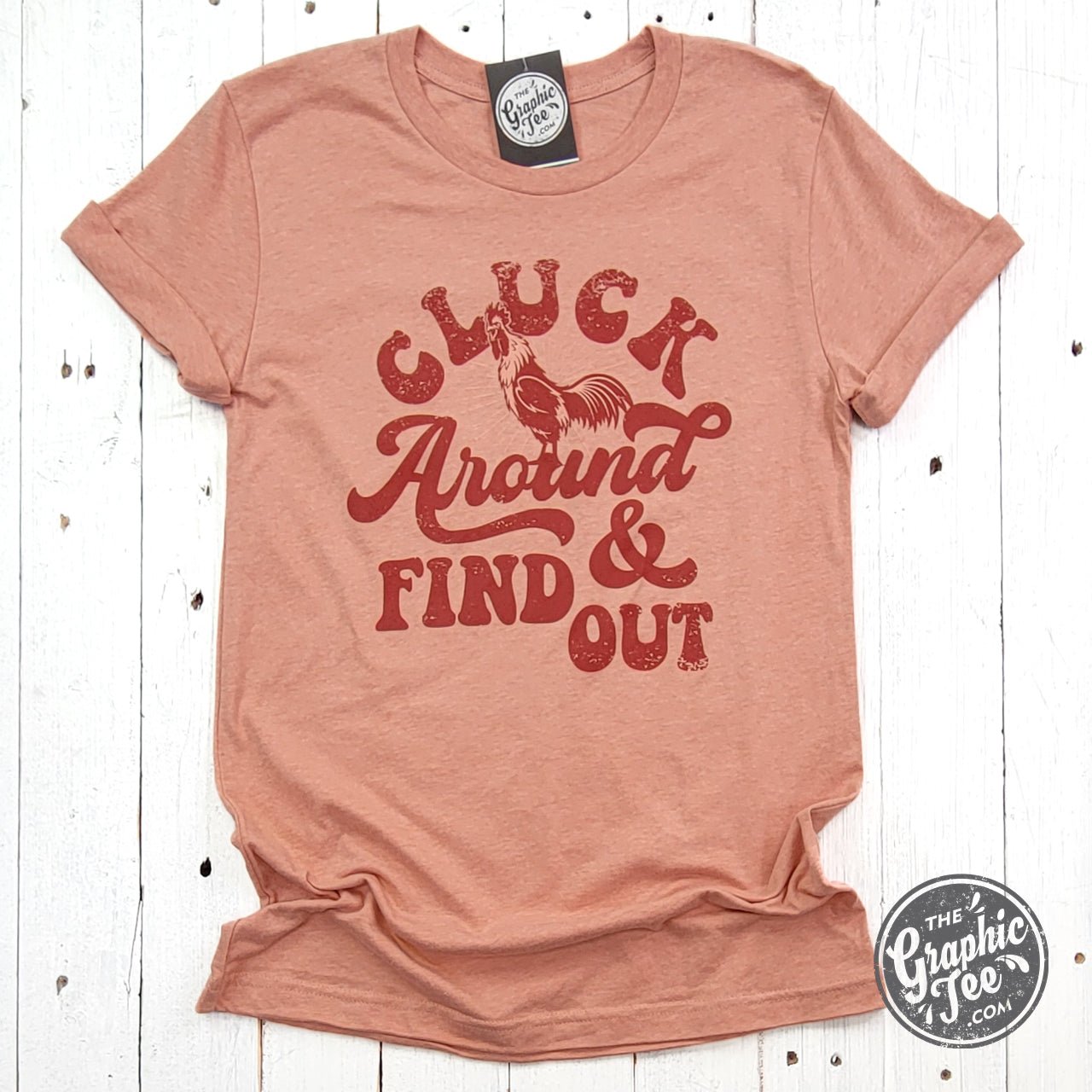 Heather Sunset short sleeve graphic tee by The Graphic Tee featuring a playful "Cluck Around and Find Out" chicken design.