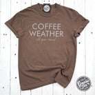 The Graphic Tee Coffee Weather All Year Round pigment dyed short sleeve graphic T-shirt showing a coffee-themed design on soft fabric.