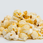 Colorado Popcorn Company Dill Pickle Popcorn in 2 oz bag, featuring green popcorn coated with dill pickle seasoning.