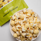 Colorado Popcorn Company Dill Pickle Popcorn in a 2 oz bag, featuring green popcorn coated with dill pickle flavor.