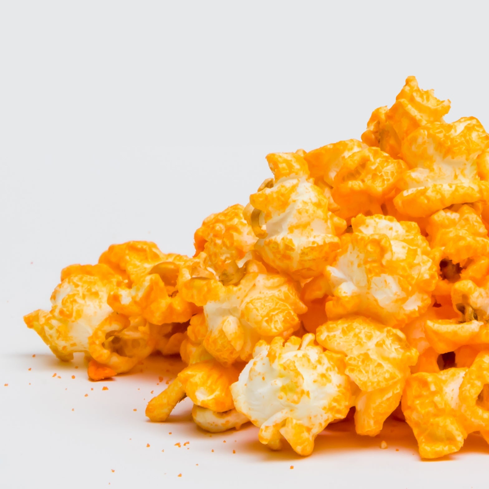 Yellow Cheddar popcorn from Colorado Popcorn Company in a 2 oz bag, featuring vibrant yellow cheese-coated popcorn kernels.