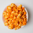 Yellow Cheddar Popcorn by Colorado Popcorn Company in a 2 oz bag, showing vibrant yellow cheddar-coated popcorn kernels.