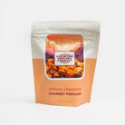 Yellow cheddar popcorn from Colorado Popcorn Company in a 2 oz bag, crispy and flavorful snack with vibrant yellow color.