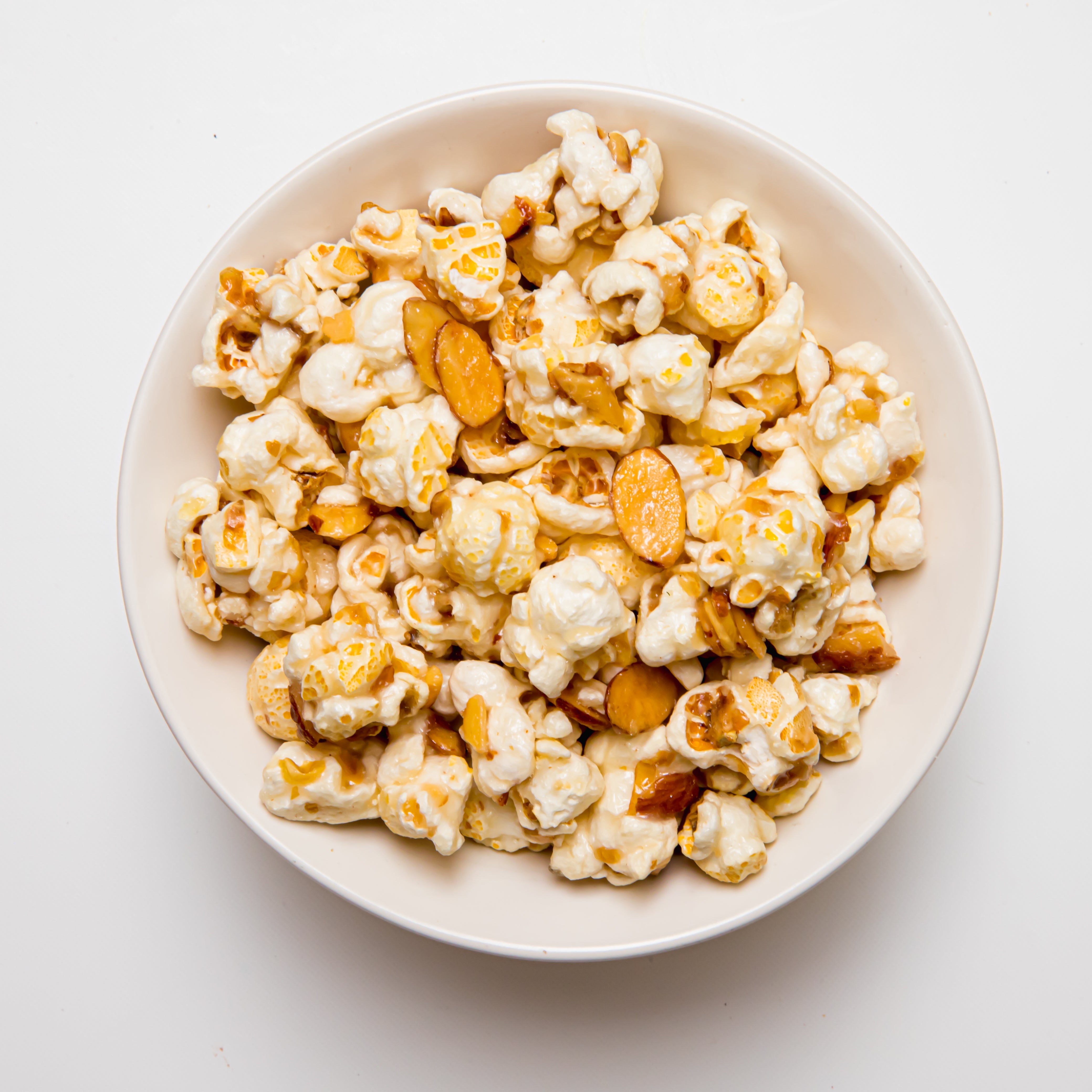 Amaretto flavored popcorn in a 5 oz bag from Colorado Popcorn Company, with caramel and almond glaze visible.