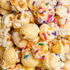 Colorado Popcorn Company birthday cake popcorn in a 5 oz bag with colorful sprinkles and cake flavor accents.