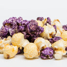 Blueberry cheesecake popcorn in a clear bag from Colorado Popcorn Company, showing blue and purple popcorn pieces with blueberries.