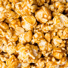 Sweet caramel peanut popcorn from Colorado Popcorn Company in a 5 oz bag, featuring crunchy popcorn coated with caramel and peanuts.