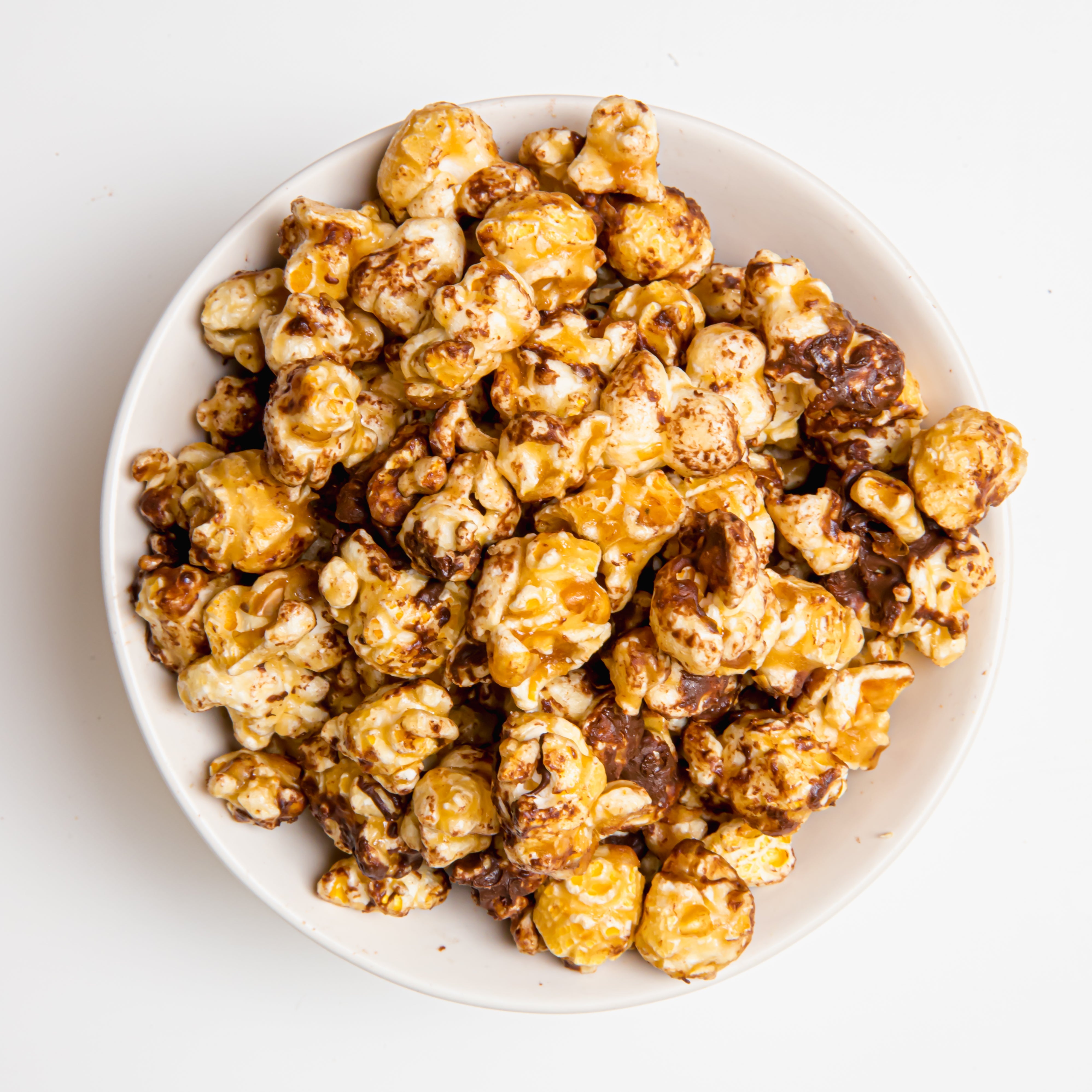Chocolate English toffee popcorn by Colorado Popcorn Company in a 5 oz bag, featuring glossy toffee-coated popcorn.