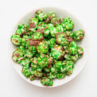 Chocolate mint popcorn in a bag by Colorado Popcorn Company, showing glossy chocolate coating and mint flavor details.