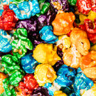 Colorado Popcorn Company Tooti Fruiti Popcorn in a 5 oz bag with colorful fruity-flavored popcorn visible.
