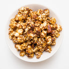 Colorado Popcorn Company's Turtle Popcorn in a 5 oz bag with caramel and chocolate coating, displayed in its packaging.