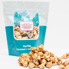 Turtle Popcorn by Colorado Popcorn Company in a 5 oz bag, featuring caramel, chocolate, and pecans on crunchy popcorn.