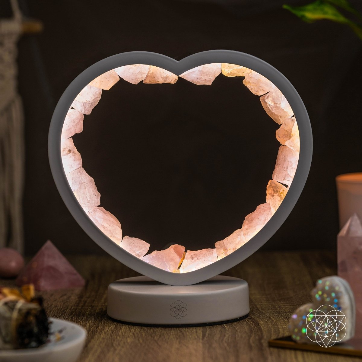 Rose quartz heart-shaped night light called Love Magnet by Conscious Items, emits a soft glow and serves as a calming decor piece.