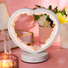 Rose quartz heart night light by Conscious Items, featuring a Love Magnet design, glowing softly as a calming bedside lamp.