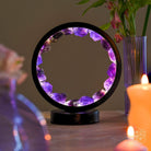 Spiritual protection amethyst night light by Conscious Items, glowing with calming purple light and featuring a crystal base.