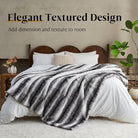 Black and white luxury faux fur blanket from CozyNest Decor, soft plush throw for couch, bed, or sofa, reversible and thick.