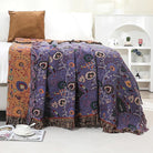 CozyNest Decor boho purple floral cotton throw blanket on a bed, showing soft breathable fabric and rustic farmhouse style.