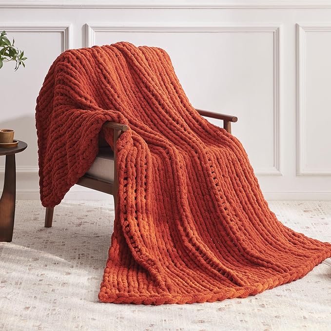 CozyNest Decor chunky knit throw blanket in orange, handmade chenille yarn, thick and plush for bed or couch decor.