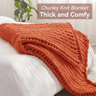 CozyNest Decor chunky knit throw blanket in orange, handmade chenille yarn, thick and soft for bed or couch decor.