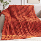 CozyNest Decor chunky orange knit throw blanket, 40x50 inches, handmade chenille yarn, cozy, machine washable for bed or couch decor.