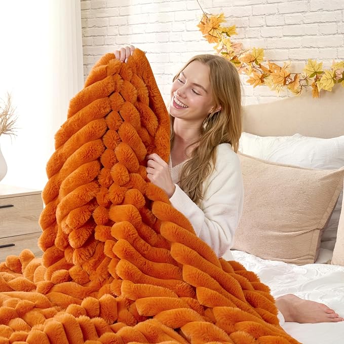 CozyNest Decor fall harvest faux fur throw blanket on a sofa, burnt orange plush striped blanket for couch or bedroom decor, 60x80 inches.