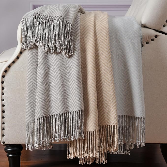 CozyNest Decor silk throw blanket in herringbone gray with hand-knotted fringe, soft, breathable, and luxurious for cozy comfort.