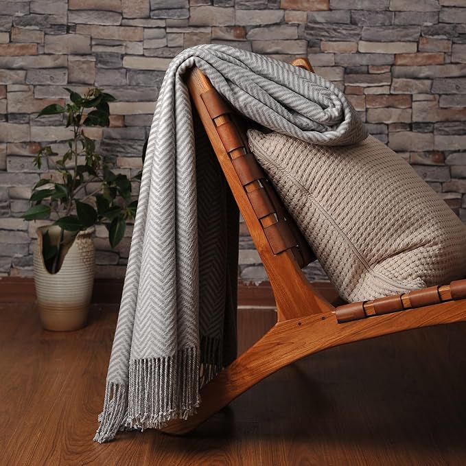CozyNest Decor Cuddle Dreams silk throw blanket in gray with hand-knotted fringe, soft, breathable, and herringbone pattern.