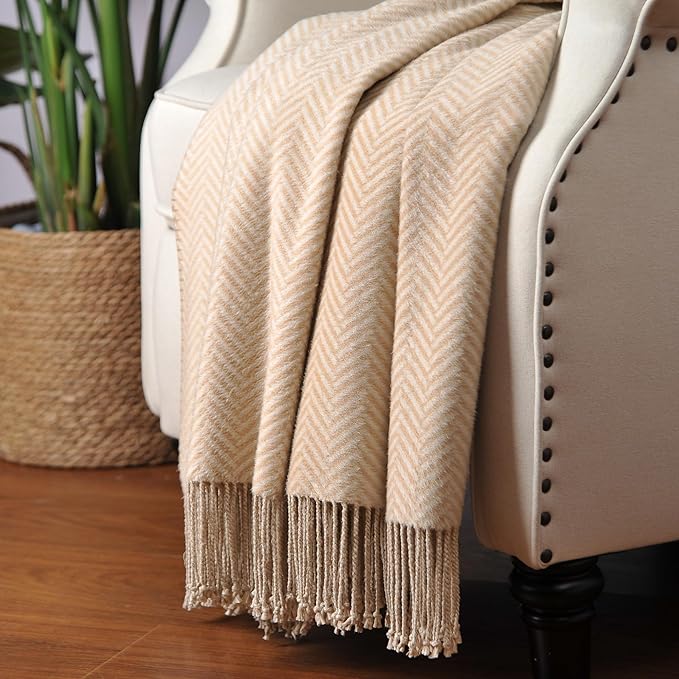 CozyNest Decor Cuddle Dreams silk throw blanket in taupe with hand-knotted fringe, soft, breathable herringbone pattern.