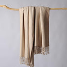 CozyNest Decor Cuddle Dreams silk throw blanket with hand-knotted fringe in taupe herringbone pattern, soft and breathable fabric.