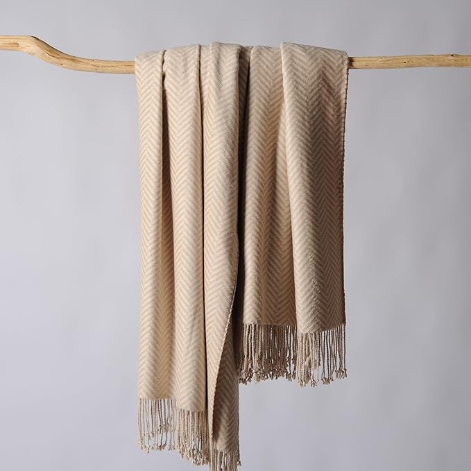 CozyNest Decor Cuddle Dreams silk throw blanket with hand-knotted fringe in taupe herringbone pattern, soft and breathable fabric.