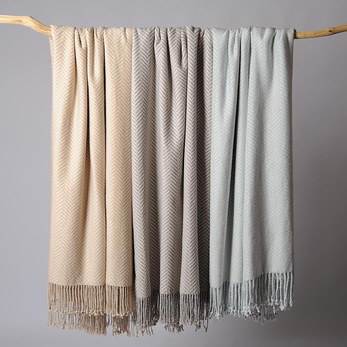 CozyNest Decor Cuddle Dreams silk throw blanket in taupe with hand-knotted fringe, soft, breathable herringbone design.