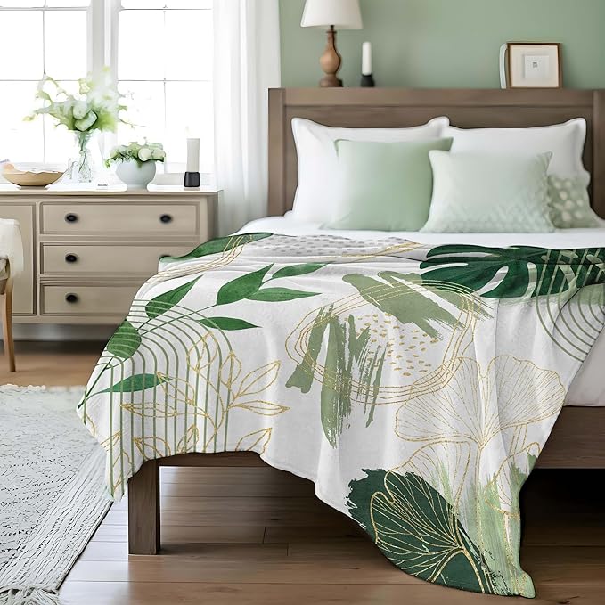 Sage green leaf throw blanket by CozyNest Decor, soft flannel with boho gold accents, 50x60 inches, cozy for couch or bed.
