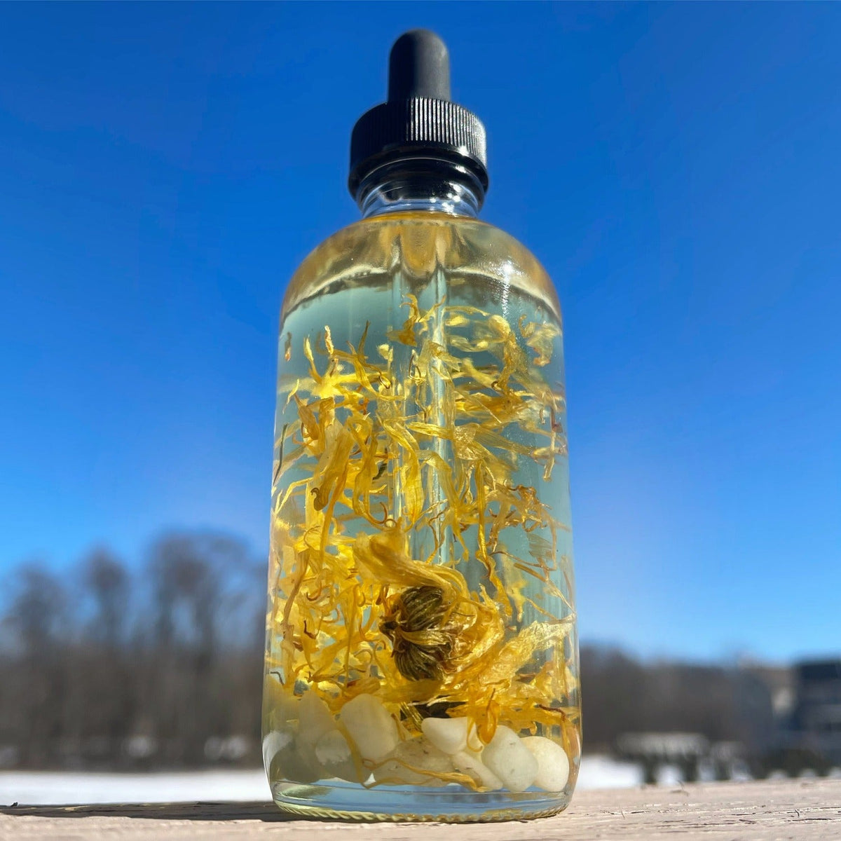 Crystal Irie Aligned Body Oil bottle with a sleek design, showcasing the nourishing body oil product.