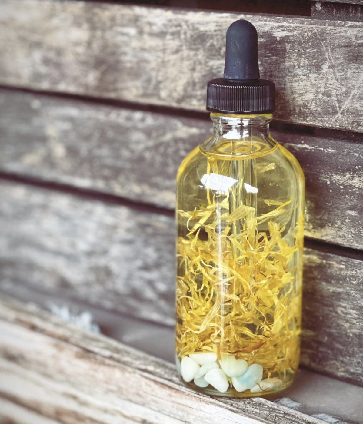 Crystal Irie Aligned Body Oil bottle with a sleek design, showcasing the nourishing body oil inside.