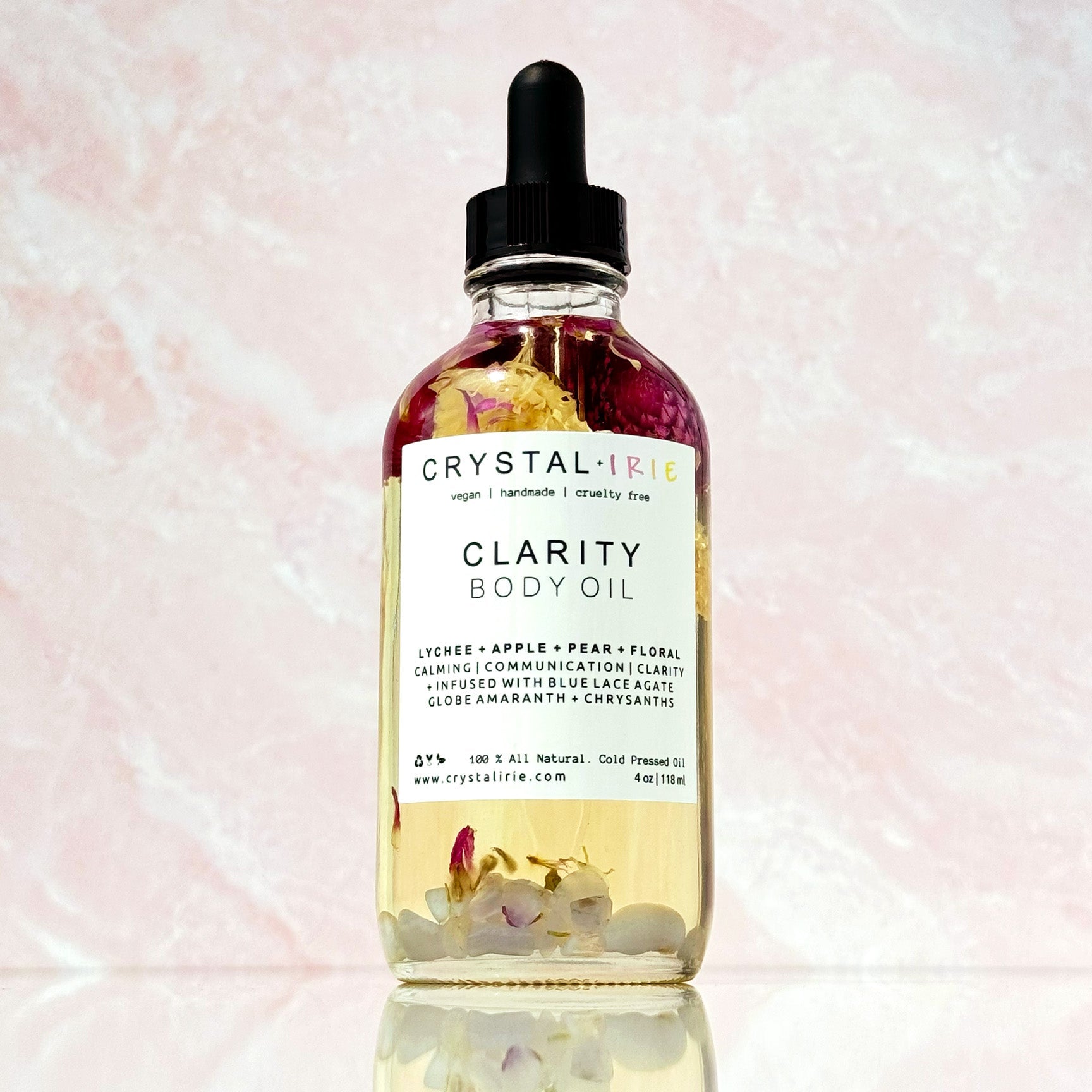 Crystal Irie Clarity Body Oil bottle with clear liquid and minimalist label, showcasing a luxurious body oil for skin hydration.