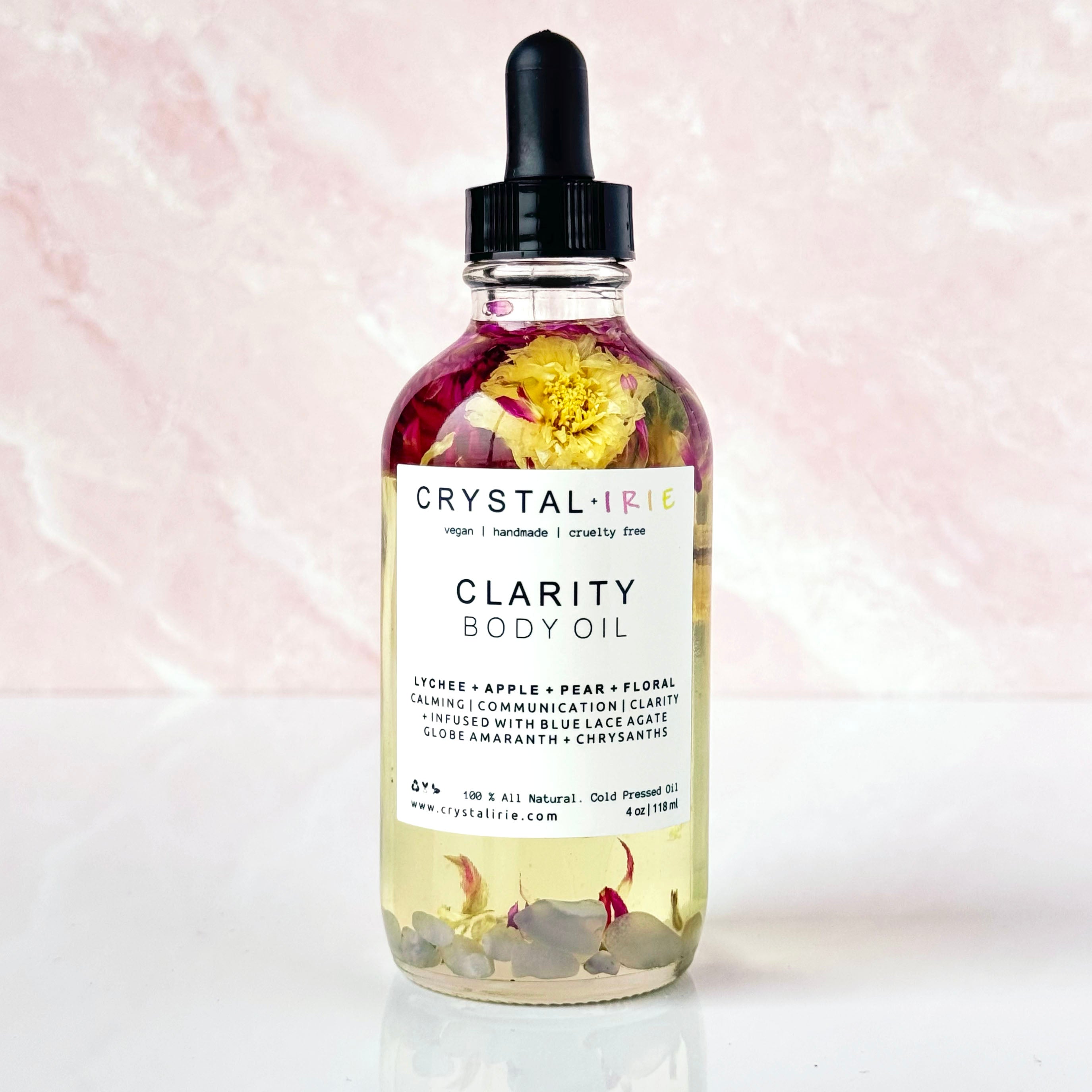 Crystal Irie Clarity Body Oil bottle with clear label, showcasing the luxurious body oil product in a sleek, elegant container.