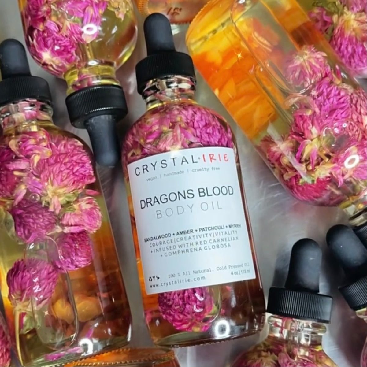 Crystal Irie Dragons Blood Body Oil in a glass bottle, featuring a rich red hue and natural ingredients for nourishing skin.