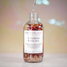Crystal Irie Goddess Rose Oil body oil bottle with rose illustration and elegant packaging on a white background.