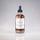Crystal Irie Goddess Rose Oil body oil bottle with rose design, showcasing the luxurious, floral-infused skincare product.