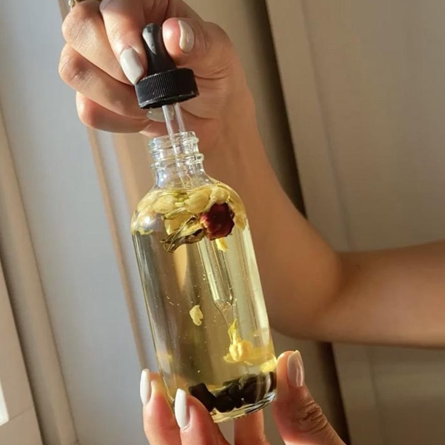 Crystal Irie Nag Champa Body Oil bottle with amber liquid and floral label, showcasing natural herbal essence for skin and aromatherapy.
