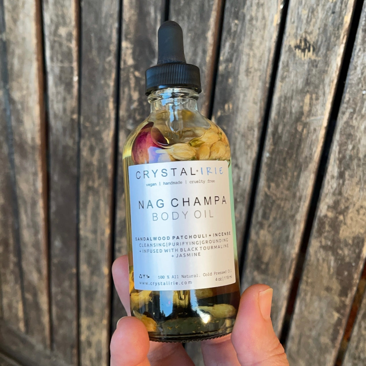 Crystal Irie Nag Champa Body Oil bottle with golden cap and label, showcasing the aromatic Nag Champa scent and smooth oil texture.