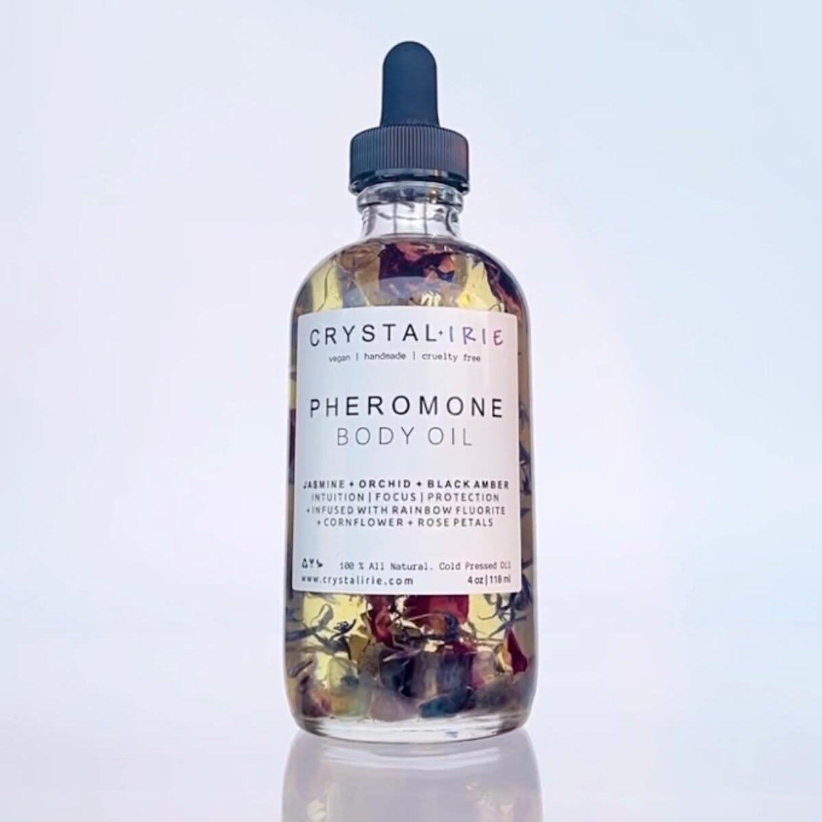 Crystal Irie Pheromone Body Oil bottle with dropper, highlighting luxurious body oil for skin enhancement and scent.
