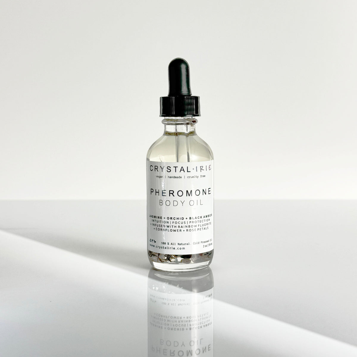 Crystal Irie pheromone body oil in a 2 oz bottle, featuring a smooth, moisturizing body oil with pheromone enhancement.
