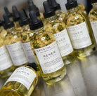 Crystal Irie ReNew Body Oil bottle with pump dispenser, showcasing the nourishing body oil in a sleek glass container.