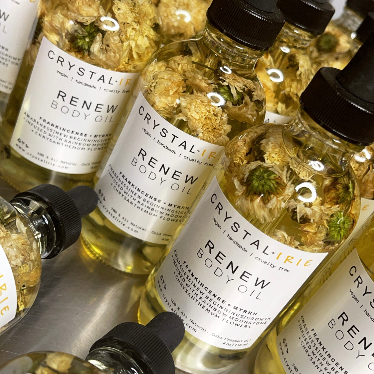 Crystal Irie ReNew Body Oil bottle with natural ingredients and elegant packaging, highlighting hydration and skin nourishment.