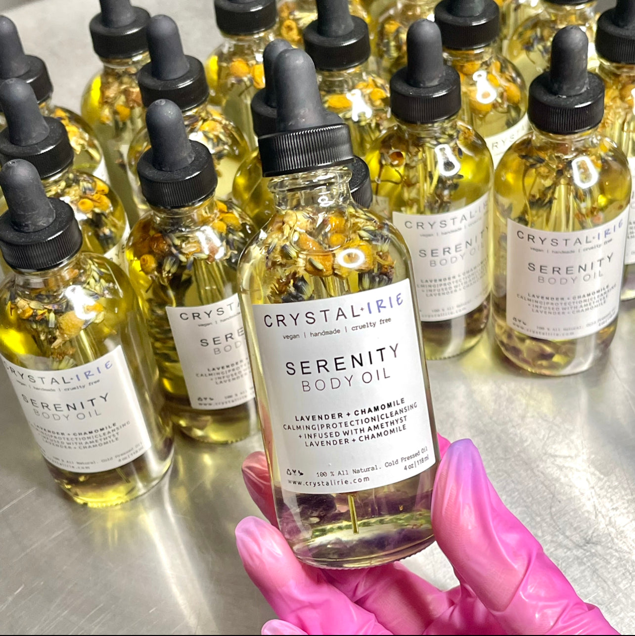Crystal Irie Serenity Body Oil bottle with a sleek design and clear label, showcasing the nourishing body oil product.