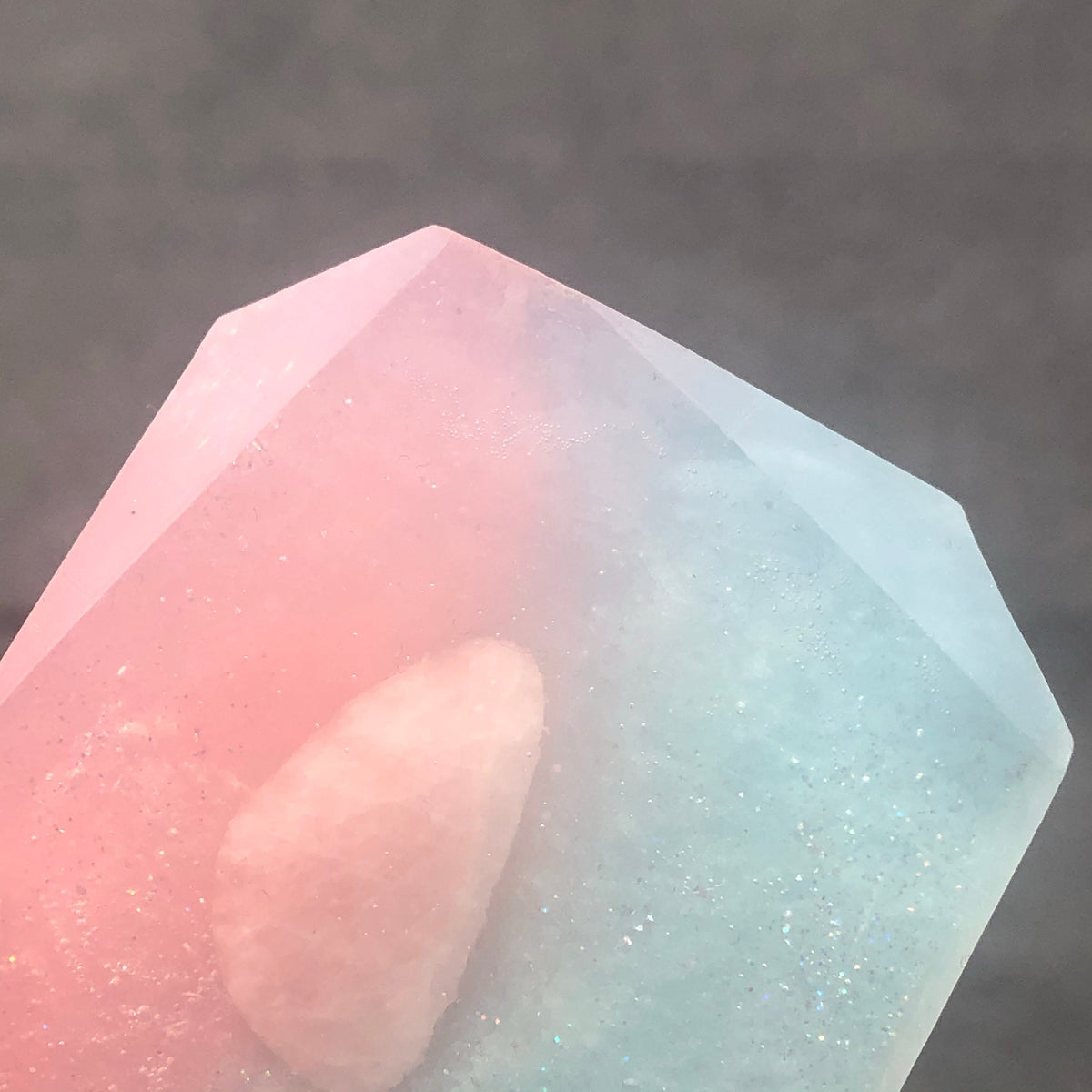 Crystal Irie Love Spelled crystal soap with a clear, smooth appearance and decorative elements visible in the image.