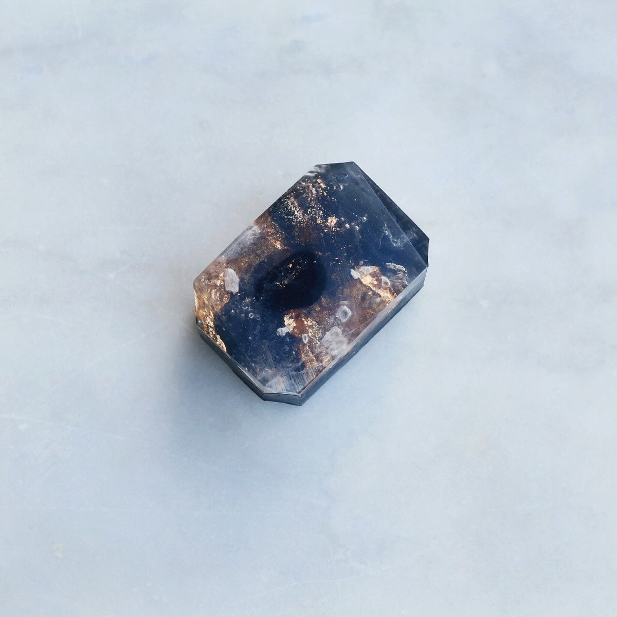Crystal Irie North Star crystal soap with a polished, star-shaped crystal and vibrant blue and purple hues.